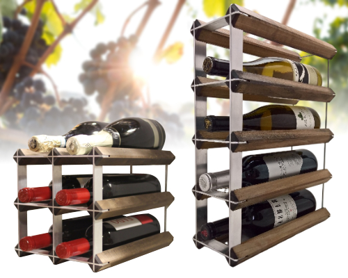 Two wooden wine racks for condos hold assorted wine bottles, with grapevines blurred in the sunny background