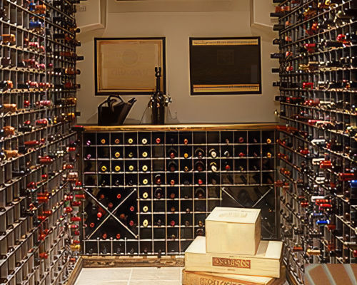 Wine cellar featuring wine racks for wine cellars filled with bottles, framed art on the wall, and boxes stacked on the floor